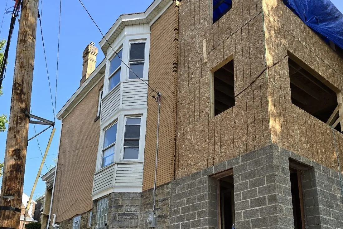 A house closed in with block, sheathing and new windows