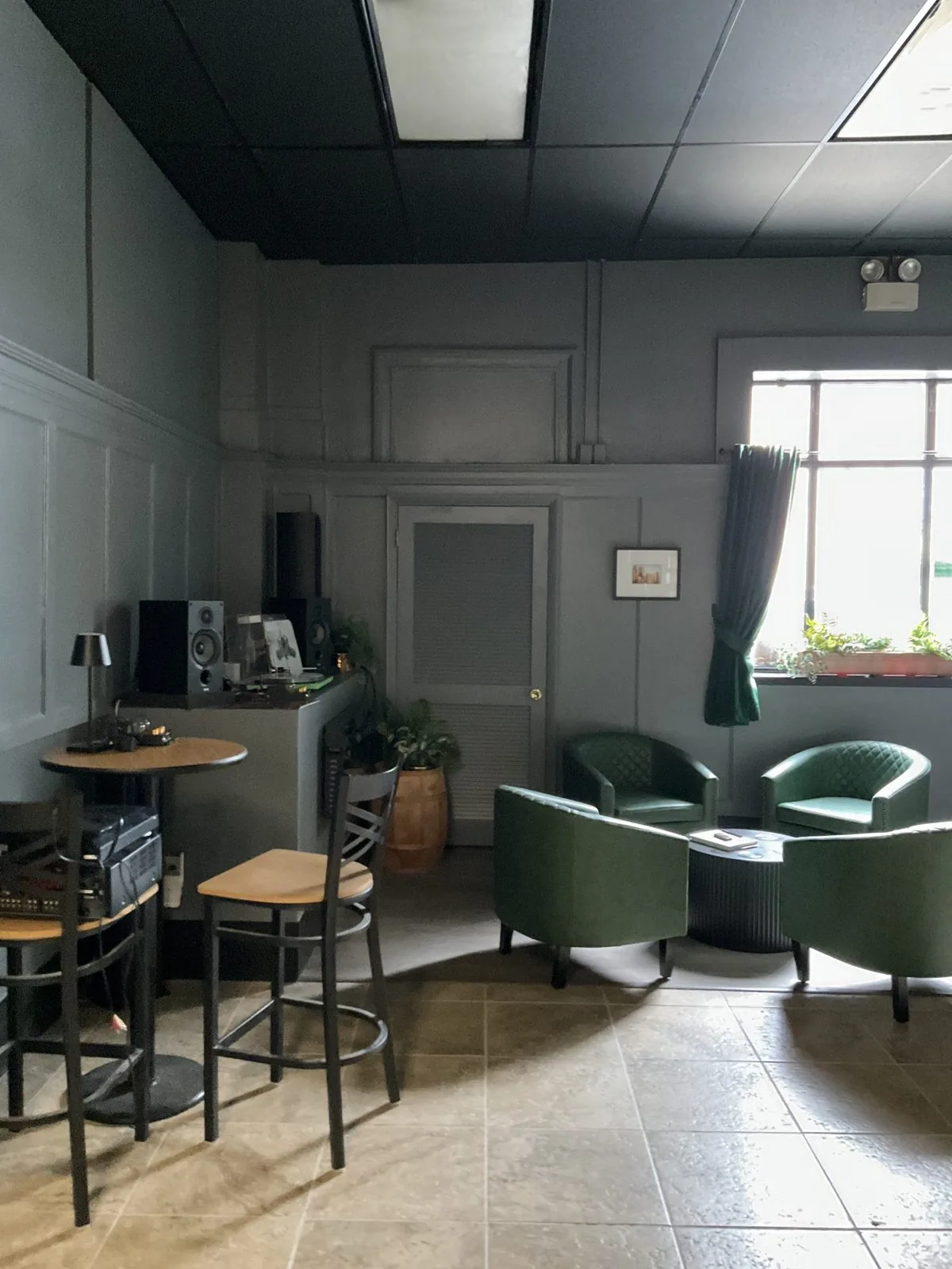 A finished commercial lounge with seating and paneled walls