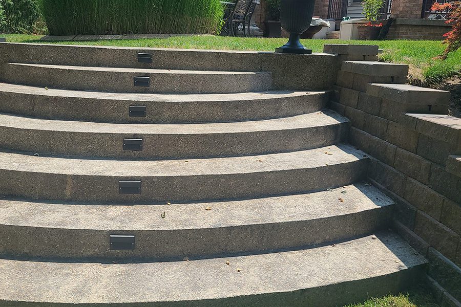 Curved stone steps with lighting set into the risers